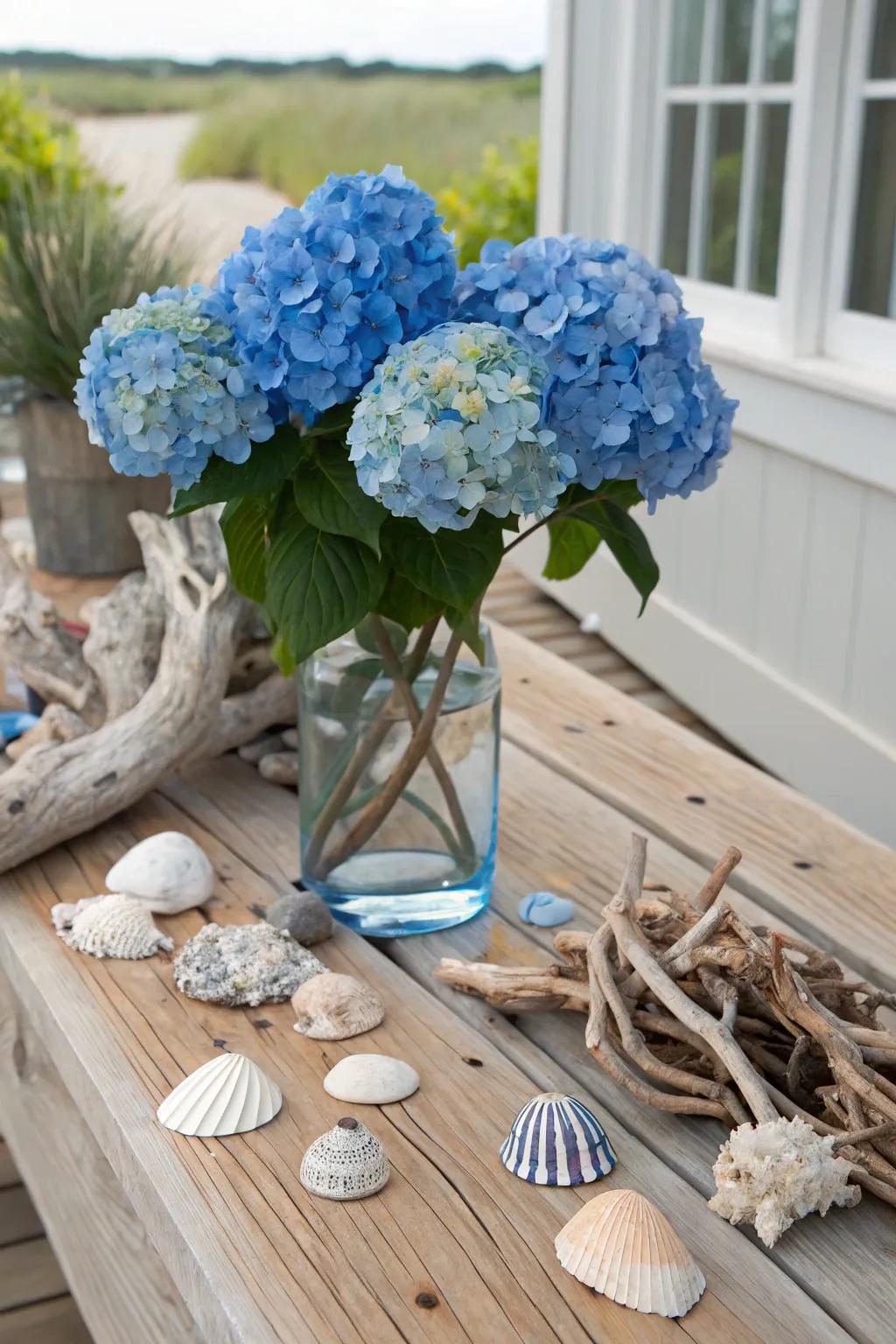 A coastal-themed centerpiece featuring azure hydrangeas and seashells.