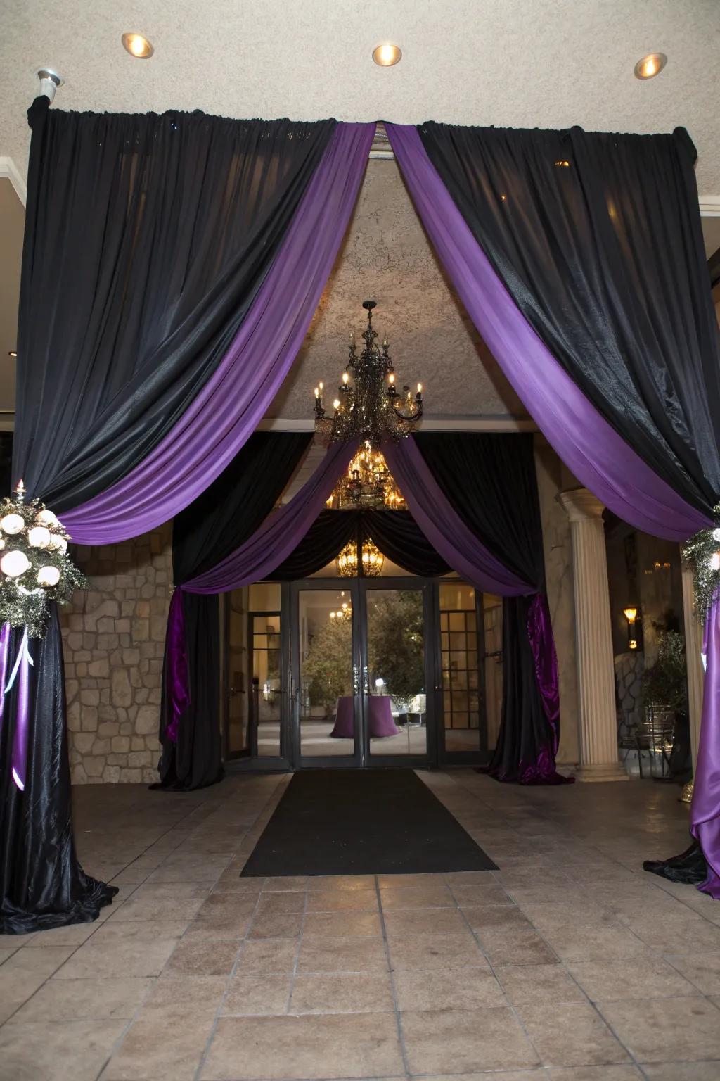 Sophisticated venue entrance decorated with dark and purple fabric.