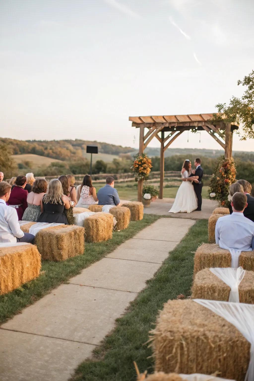 A rustic wedding ceremony featuring straw block seating covered in comfortable material.