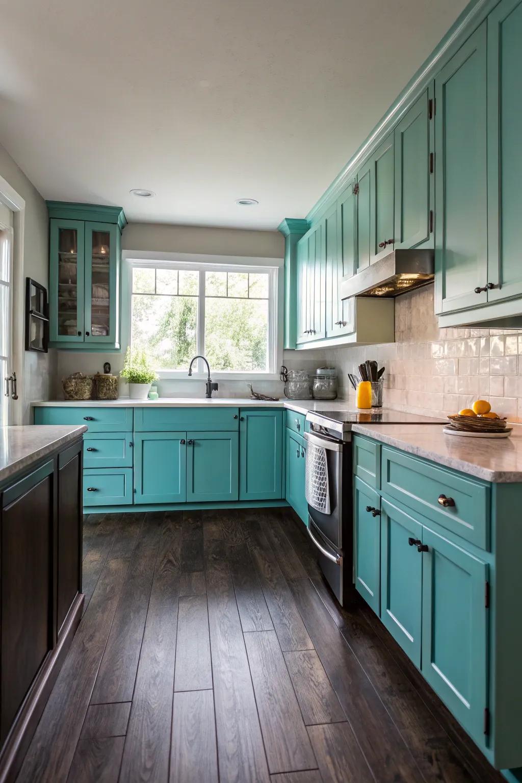 Dramatic dim floors complementing turquoise kitchen cabinets.