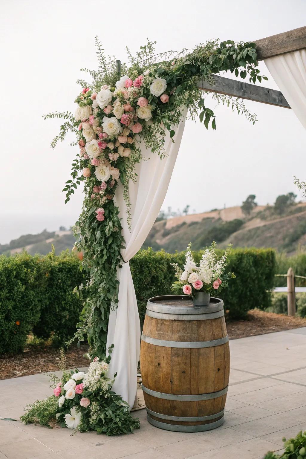 A countryside arch using wine cask bases, ideal for vineyard weddings.