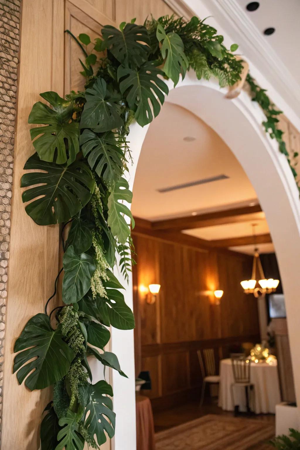 A lush hanging decoration of split-leaf philodendron fronds enhancing an archway.