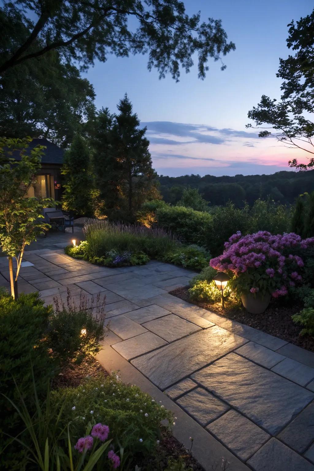 A slate patio exquisitely illuminated with landscape lighting.