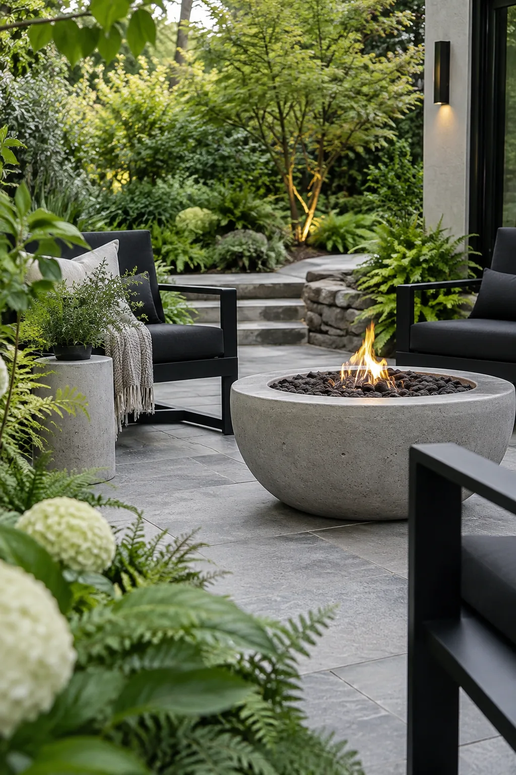 Sleek black chairs surrounding a modern concrete fire bowl
