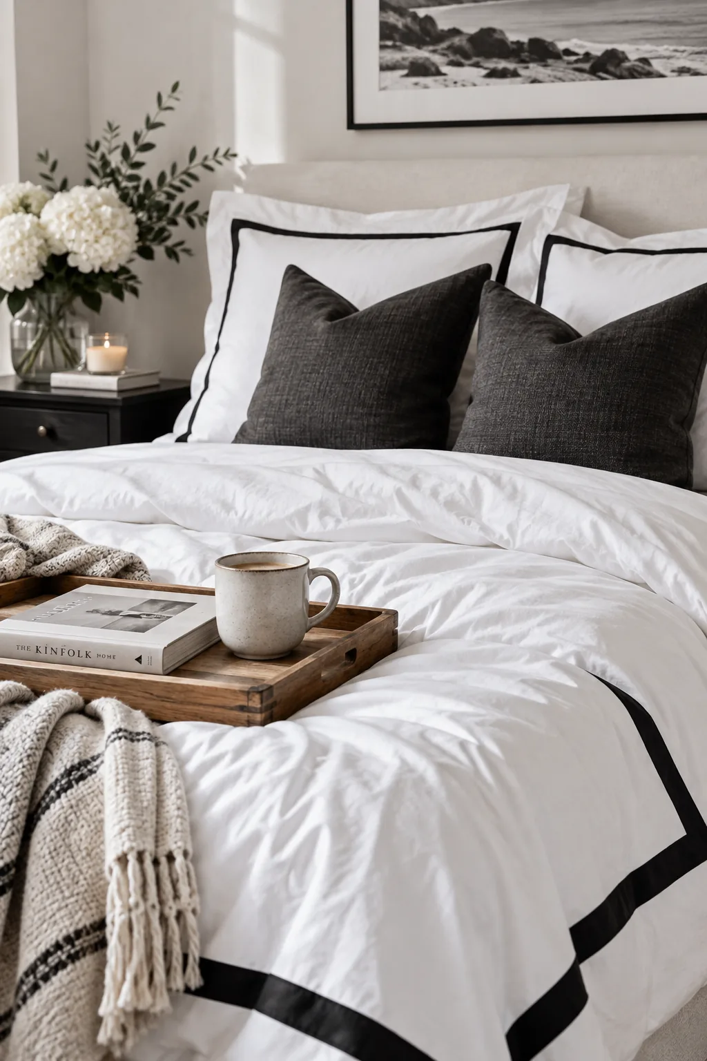 Crisp white hotel-style bedding with bold black borders on the pillows and duvet