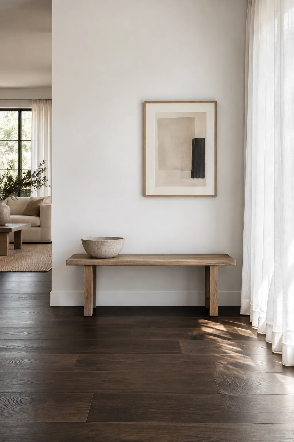 Living room with dark wood floors and crisp white walls