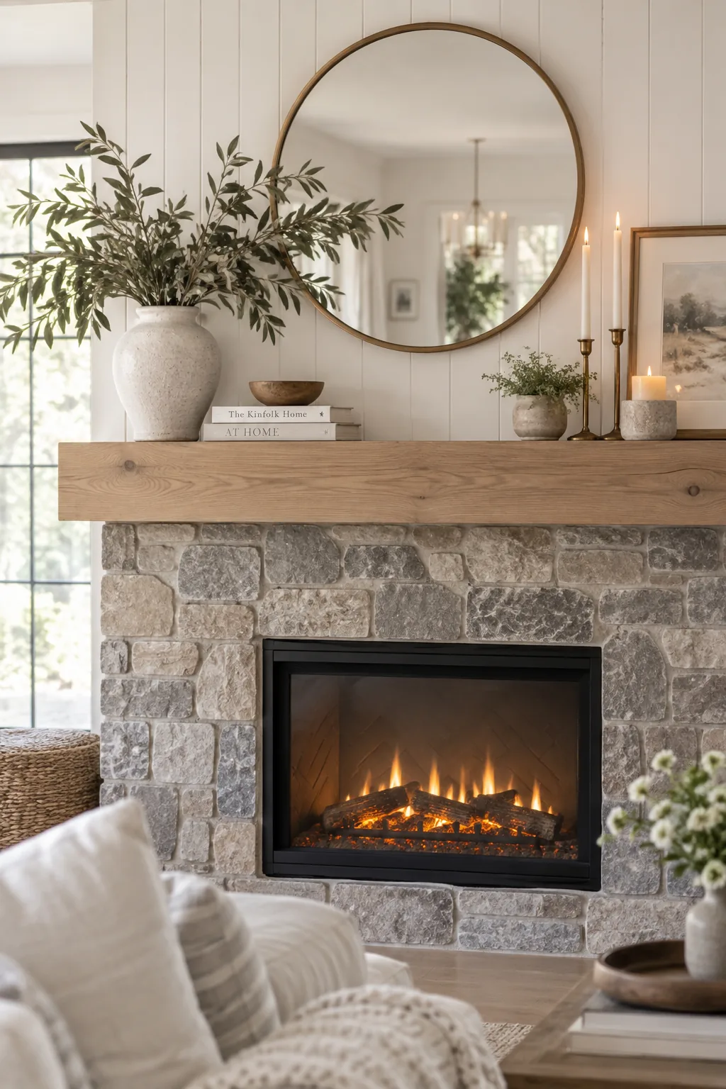 Fireplace wall with stone veneer on the bottom and white shiplap on top.