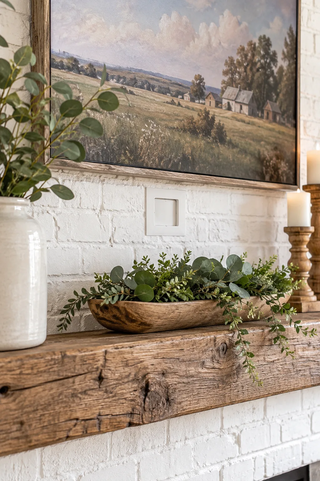 Clean white painted brick wall between a wood mantel and a flat screen TV, featuring a recessed white outlet plate with no cords.