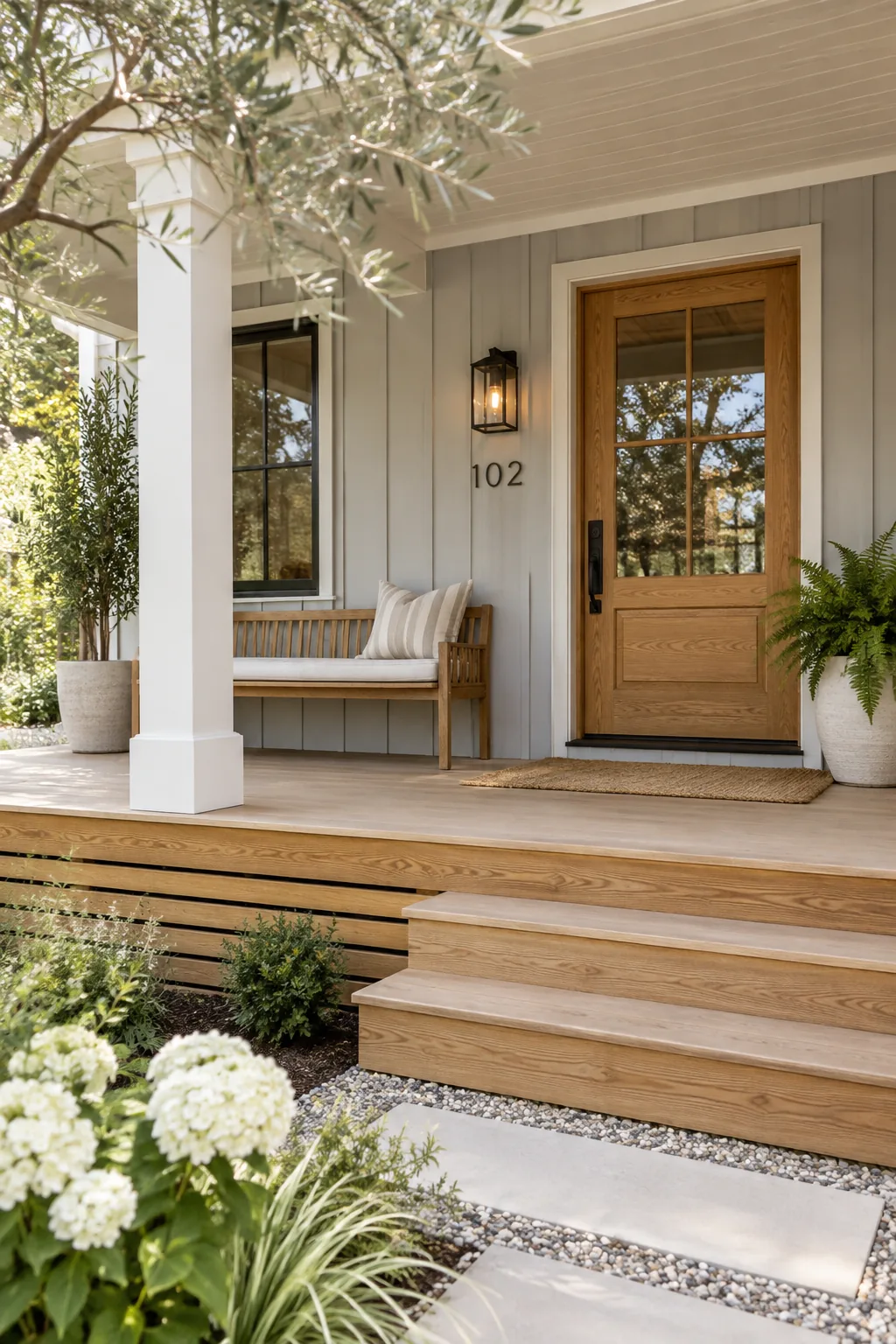 The bottom of a porch skirted with horizontal wooden slats stained in a warm tone.