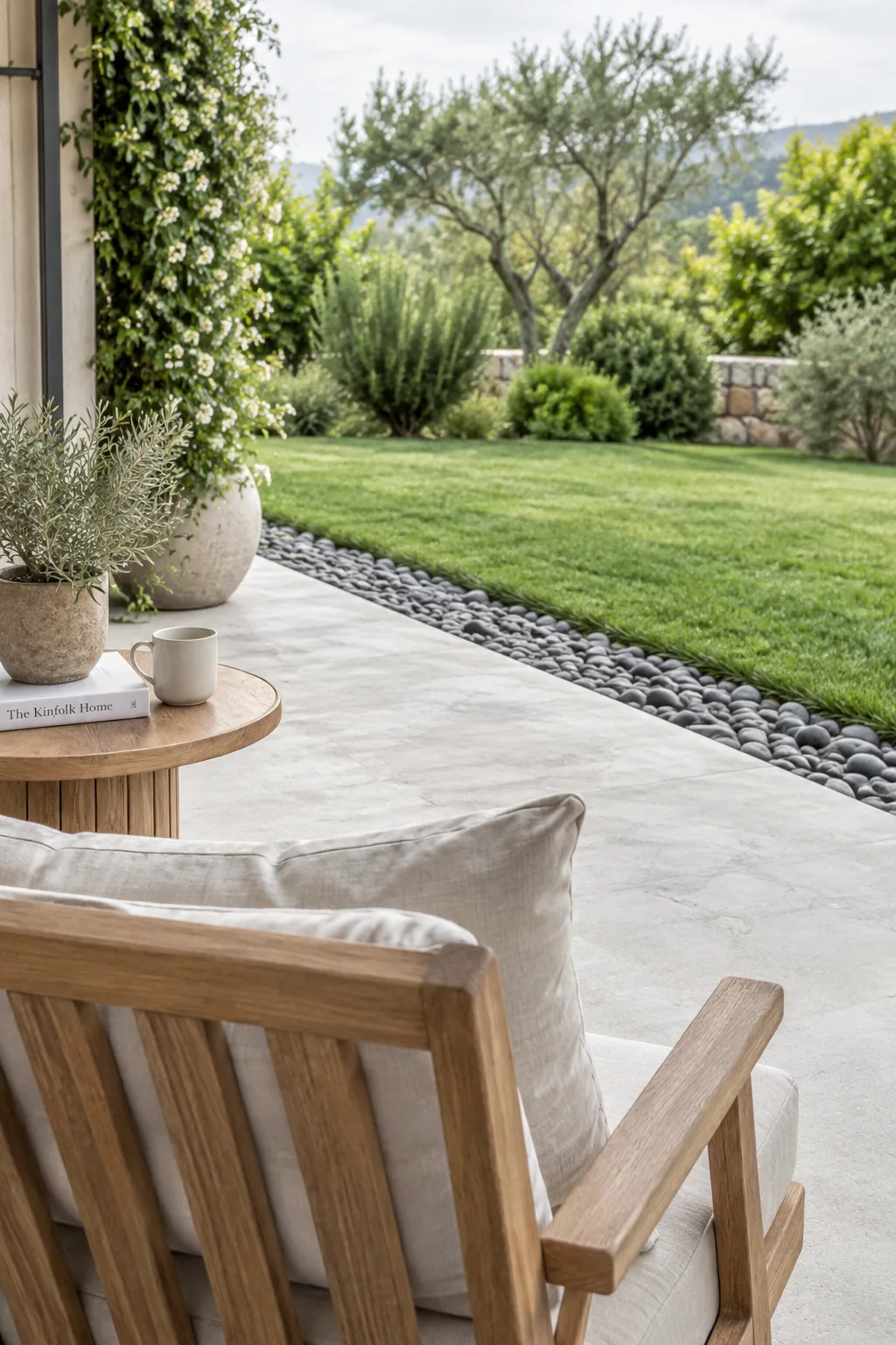 Concrete patio edged with a neat border of smooth river rocks