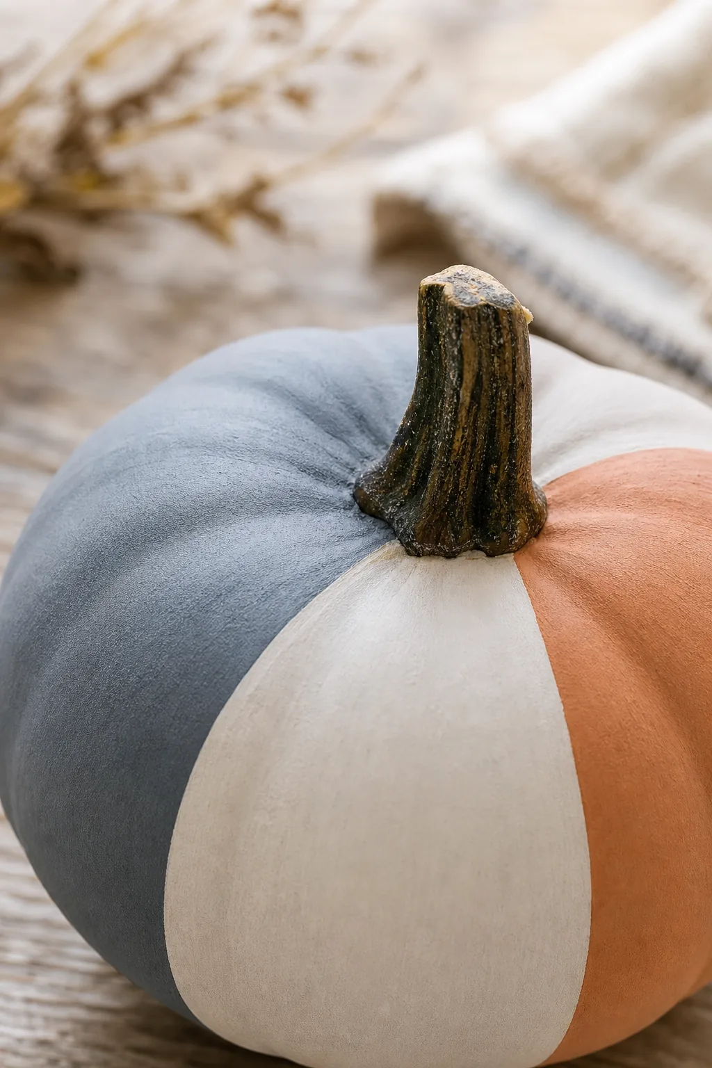 Close-up of a smooth, matte painted surface on a mini pumpkin.