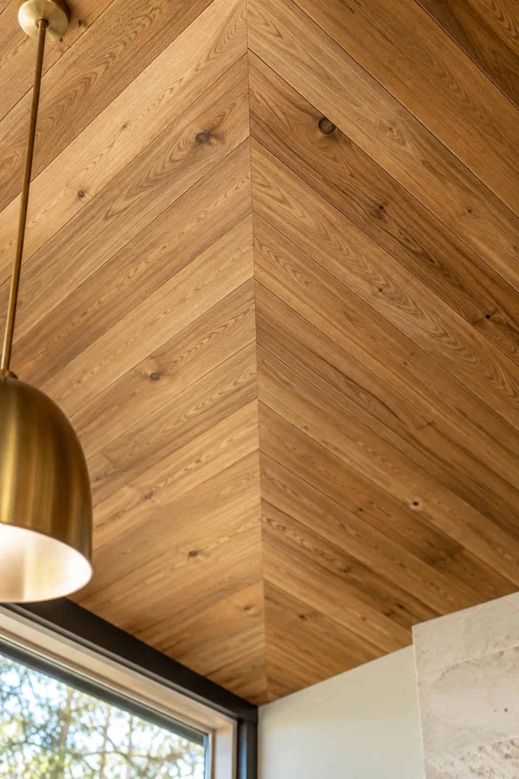 Intricate chevron patterned wood ceiling in a minimalist room
