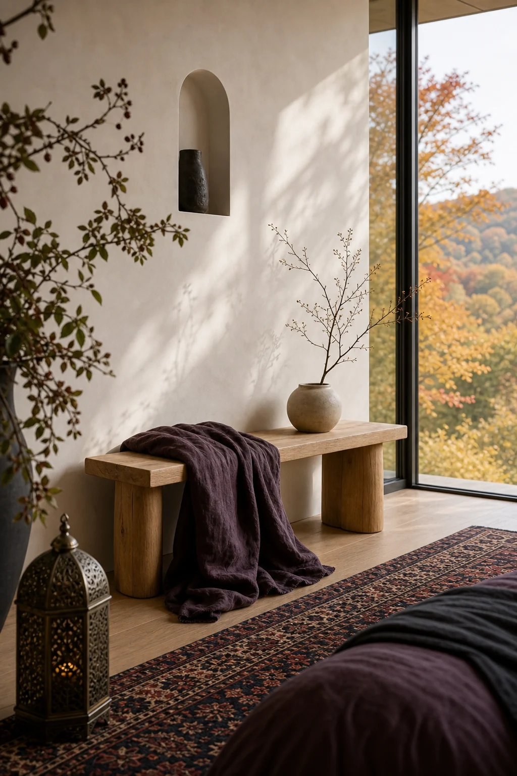 Clean-lined pale oak bench draped with a heavy, unfringed faded aubergine linen throw.